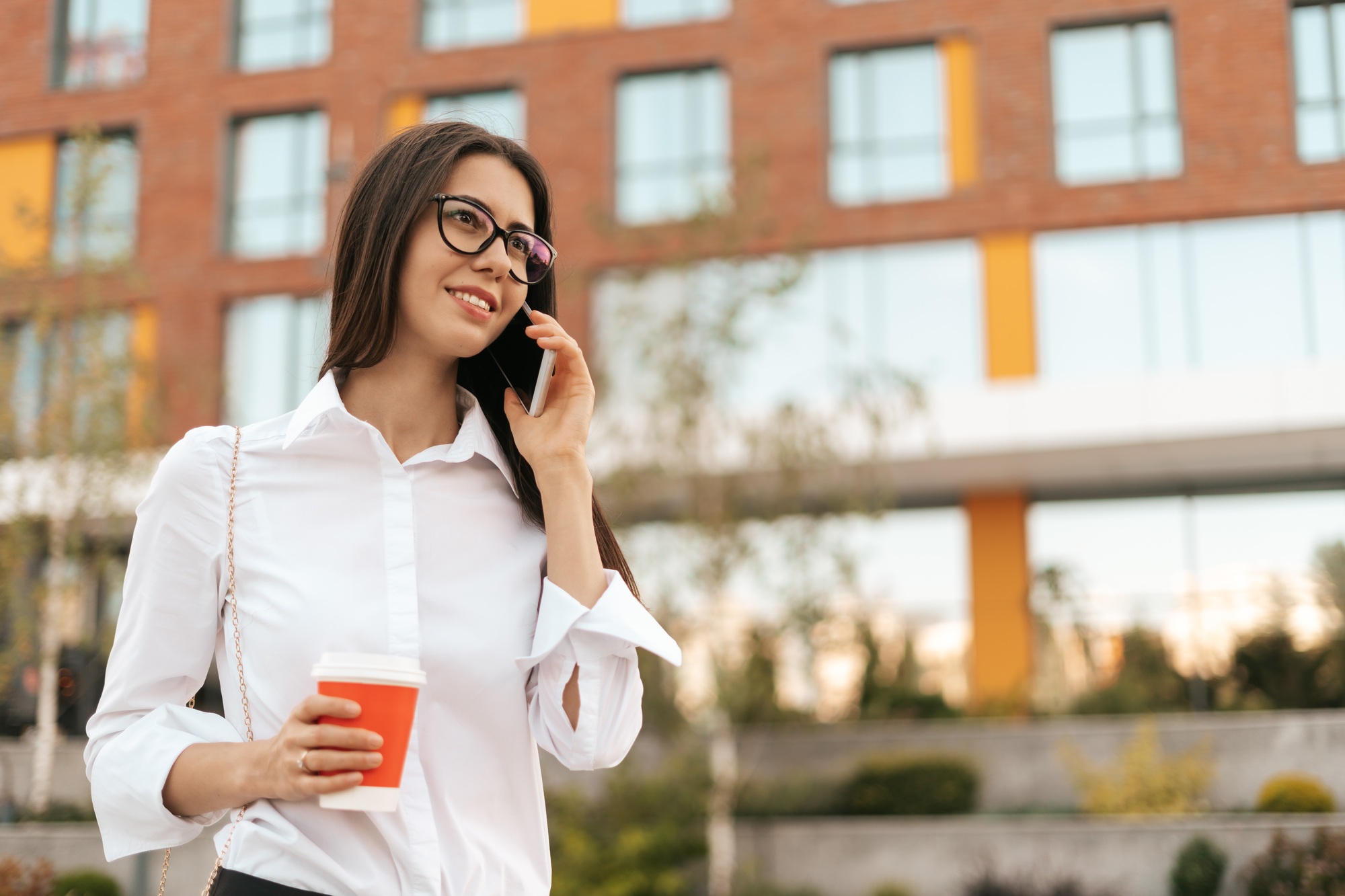 Smiling business woman talking on phone